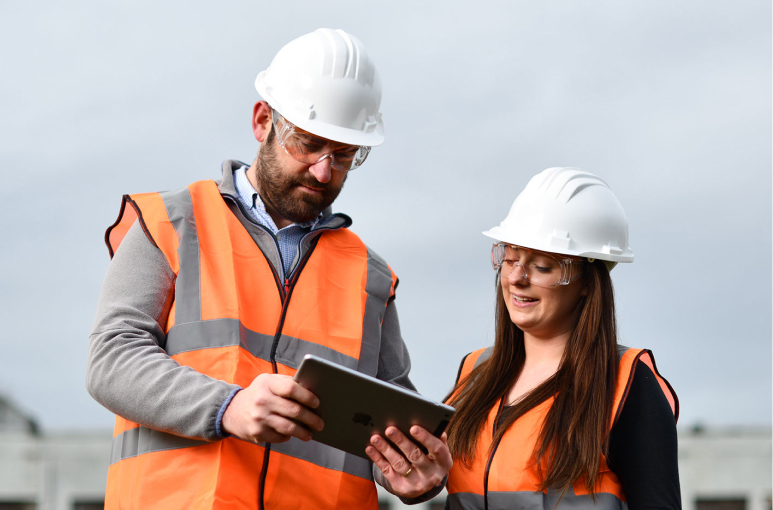 project manager on a construction site walking with a walkie talkie